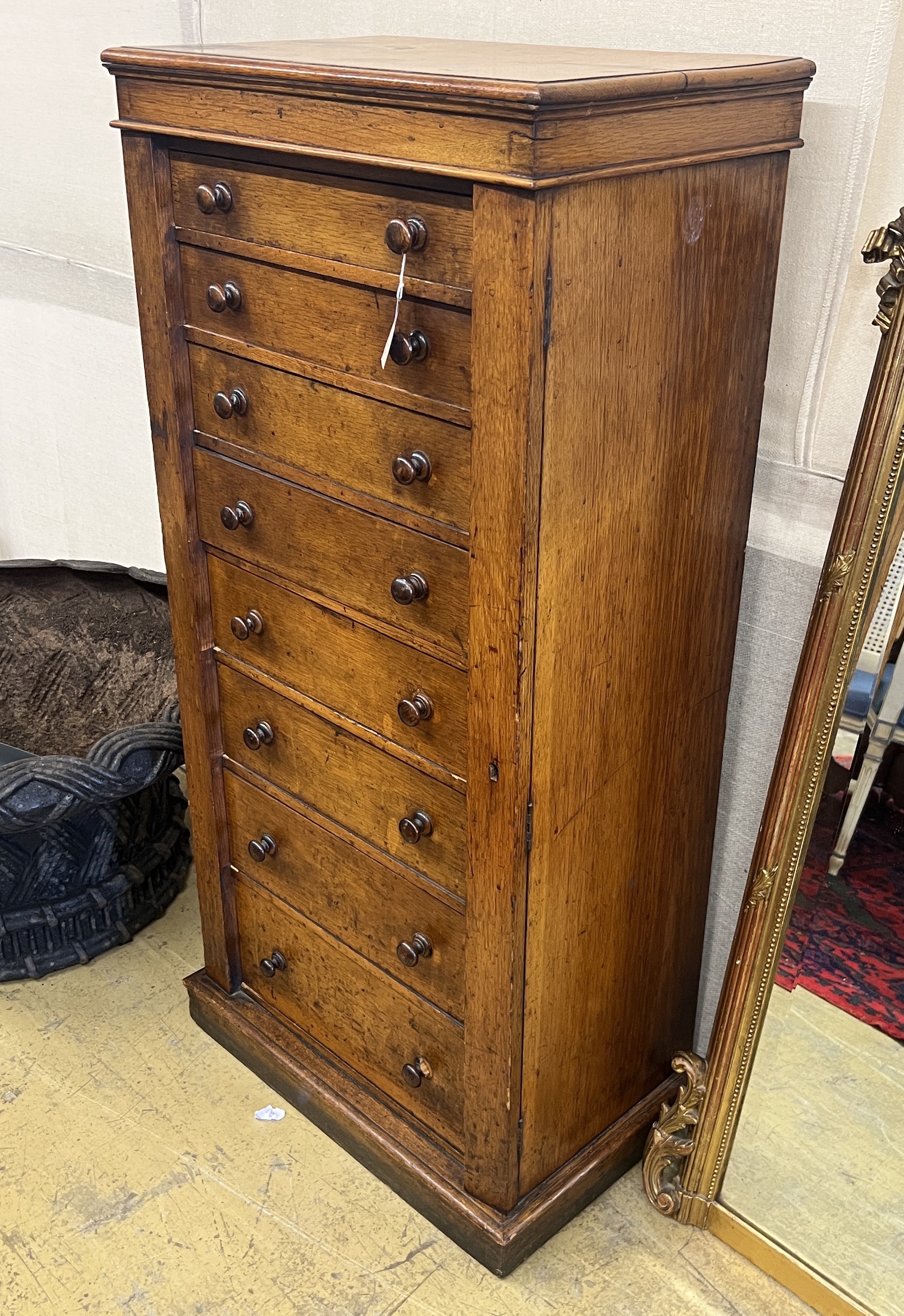 A Victorian oak eight drawer Wellington chest, width 60cm, depth 38cm, height 127cm